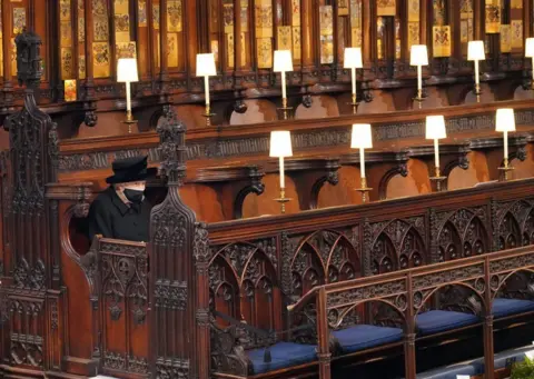 PA Media Queen Elizabeth II takes her seat for the funeral of the Duke of Edinburgh in St George's Chapel, Windsor Castle, Berkshire. 17 April 2021.