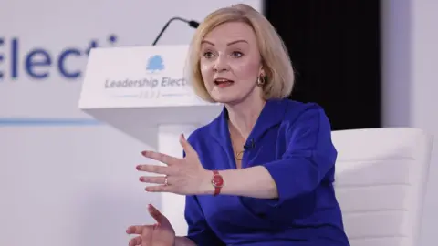 EPA Prime ministerial hopeful Liz Truss speaking on stage at an event