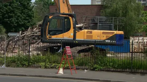 Demolition site where derelict pub building damaged by fire was