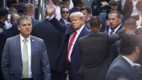 Getty Images  Trump waves to supporters