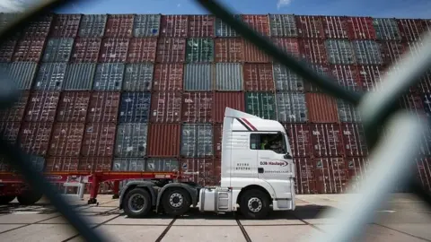 Getty Images Truck in front of containers