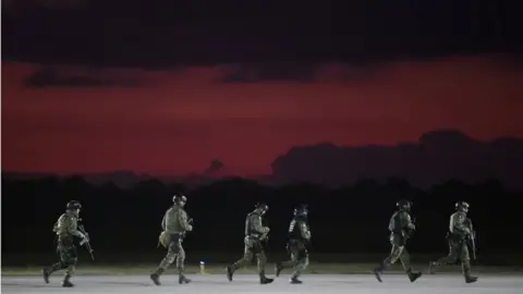 AFP Members of the Mexican Army Special Forces run upon their arrival to the Airport of Culiacan, Sinaloa state, Mexico, on October 18, 2019