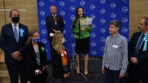 PA Media Lib Dem Sarah Green makes a speech after being declared winner in the Chesham and Amersham by-election, where she defeated Conservative candidate Peter Fleet (left)