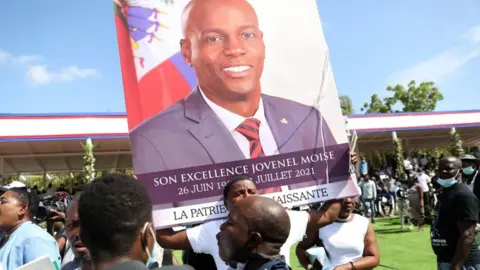 AFP Mourners attend the funeral of slain Haitian President Jovenel Moïse on July 23, 2021, in Cap-Haitien, Haiti, the main city in his native northern region.