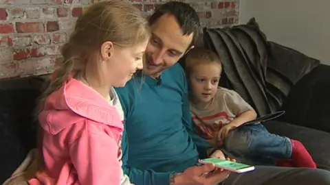 Nick Thomas with Cadi and Harri listening to an audio book online