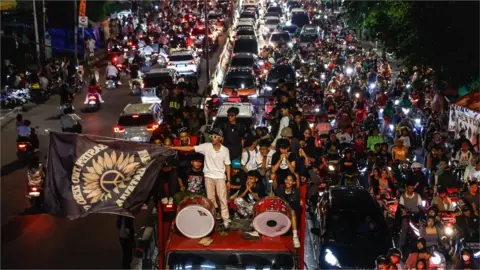 EPA People on motorbikes and on top of of a truck celebrating in Jakarta, Indonesia