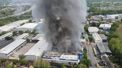 Smoke billowing from a fire at a storage unit in Byfleet in May 2023