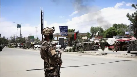 EPA An Afghan soldier stands guard near the scene of an attack at an MSF (Doctors without Borders) clinic in Kabul, Afghanistan, 12 May 2020.