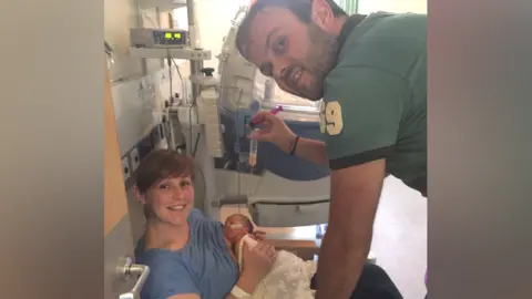 Family image Ceri with husband Elis and new baby Seth in hospital