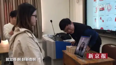 BEIJING NEWS A Chinese student registering for her class using facial recognition