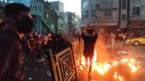 EPA People clash with police during a protest following the death of Mahsa Amini, in Tehran, Iran (21 September 2022)