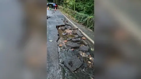 Burst water pipe on the B5035 Crich Road, between Whatstandwell and Crich, in Derbyshire