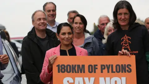 Getty Images Dame Priti Patel at a protest against proposed pylons in her Essex constituency