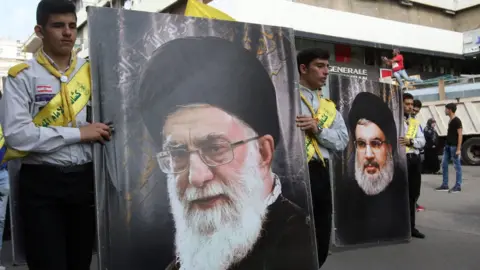 AFP Hezbollah supporters carry posters of Hezbollah leader Hasan Nasrallah (R) and Iran's Supreme Leader Ayatollah Ali Khamenei in the southern Lebanese city of Nabatieh on November 8, 2017