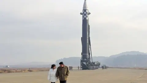 KCNA Him Jong-Un with his daughter at a missile test