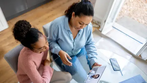 Getty Images Mother and daughter have a virtual appointment with a doctor from home