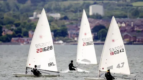 PA Media Sailors from Holywood Yacht Club took to their Laser dinghies on Belfast Lough