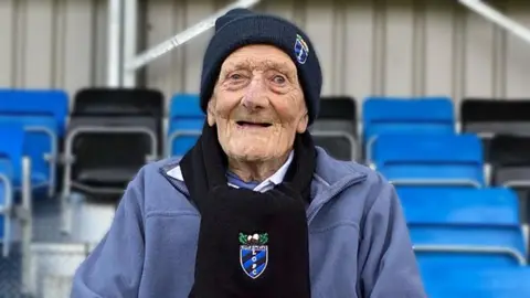 Gordon Carter sitting in the stand named in his honour