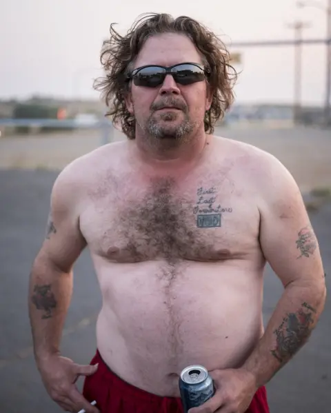 Martin Eberlen A man holds a beer can