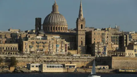 Getty Images Valletta, including the dome of the Basilica of Our Lady of Mount Carmel, stands on March 29, 2017 as seen from opposite the bay in Sliema, Malta