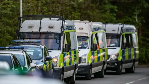 Vedat Xhymshiti  Police vans at scene