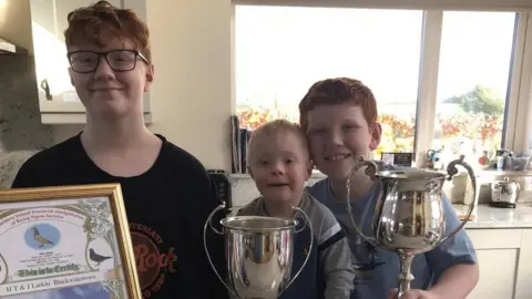 Alan Larkin  Harry, Tom and Joseph Larkin with their awards for pigeon racing