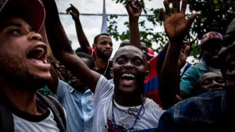 AFP Supporters of Democratic Republic of Congo joint opposition presidential candidate Martin Fayulu sing and dance ahead of his arrival in Kinshasa to launch his campaign on November