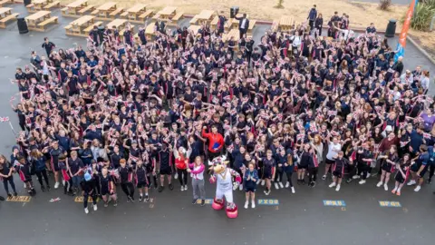 Getty Images Crowd of children with mascot