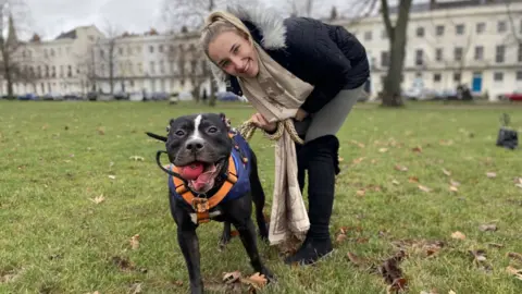 BBC Elise Philcox in the park with her dog on a lead