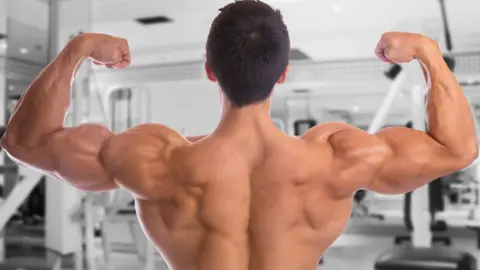 Thinkstock A shirtless man flexing his biceps