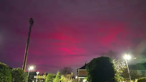 Liam Blundell A telegraph pole backlit by the red light that covers the sky