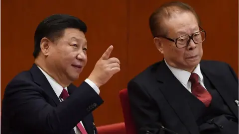 AFP Chinese President Xi Jinping (L) talks to China's former president Jiang Zemin (R) during the closing of the 19th Communist Party Congress at the Great Hall of the People in Beijing on October 24, 2017.