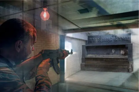 George Logan An abstract image of a hunter shooting at a lion in a small enclosed space