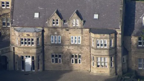 Aerial view of Whorlton hall. It is a large two storey manor house type building with dormer windows in the roof.