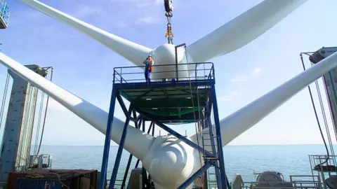 Getty Images A ship ready for lifting into place a wind turbine off the coast of Kent