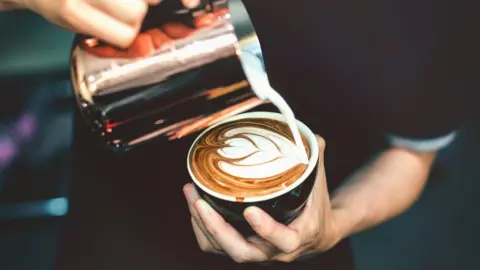 Getty Images man making a coffee