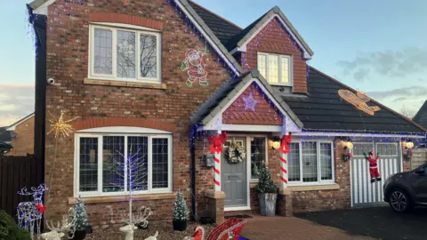 Photograph of a house with Xmas decorations on Wrenbury Drive in Rochdale