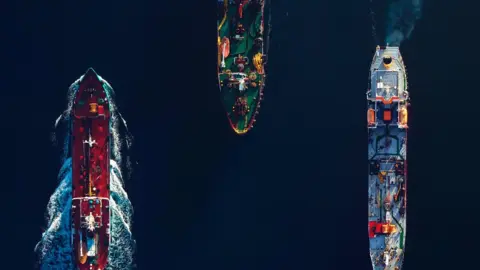 Getty Images Three commercial ships from above