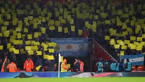 Getty Images Fans hold up placards