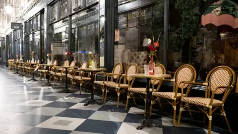 Getty Images High Street Arcade in Cardiff with empty chairs outside a tearoom