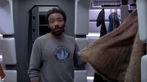 Star Wars/YouTube Donald Glover shows off his cape closet in the Millennium Falcon