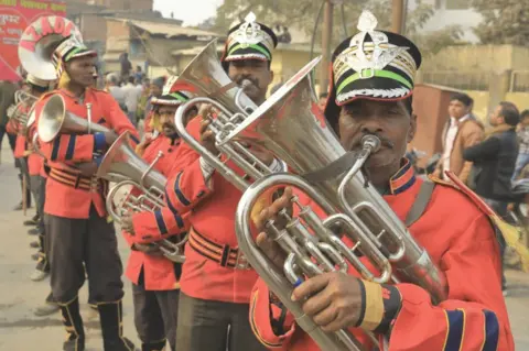 BBC The band in the procession by the Kinnar Akhara