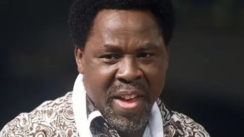 Nigerian pastor TB Joshua speaks during a New Year's memorial service for the South African relatives of those killed in a building collapse at his Lagos megachurch on December 31, 2014