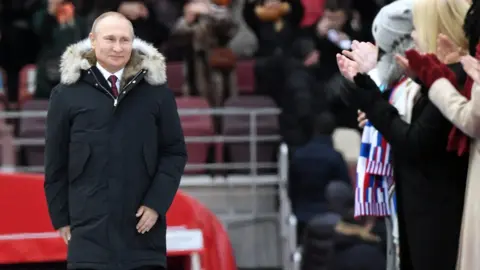KIRILL KUDRYAVTSEV Vladimir Putin is applauded at an election rally in Moscow's Luzhniki stadium on 3 March 2018.