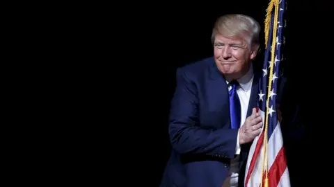 Reuters Donald Trump holding the flag of the USA