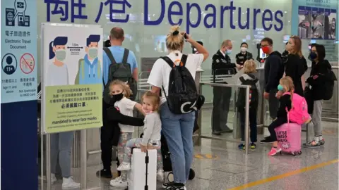 Getty Images Expat families depart Hong Kong airport as travel restrictions hit hard on Hong Kong's white collar "expat" foreign workers