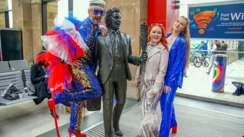 PA Media Fans pose at Liverpool Lime Street station