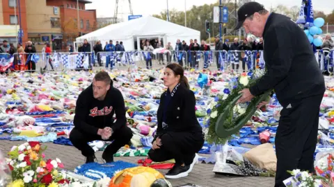 Plumb Images / Getty Images The Vardys and Alan Birchenall lay wreaths at the memorial