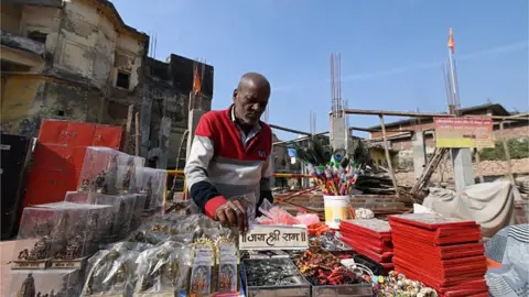 Getty Images Local vendor named Udaikant Jha selling religious items near Dashrath Mahal on December 22, 2023 in Ayodhya, India.