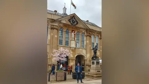 Supplied Peter Williams standing in front of Shire Hall